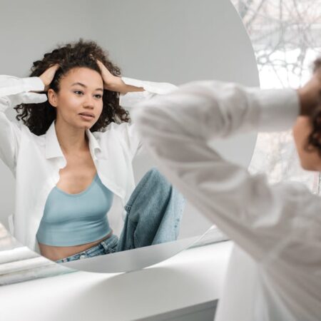 beautiful woman looking at herself in mirror